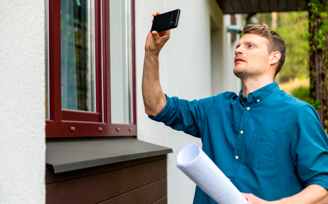 Man taking photos of house